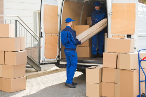 Man with van loading furniture for a move in Putney