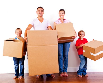 Removal van team loading household items into a van
