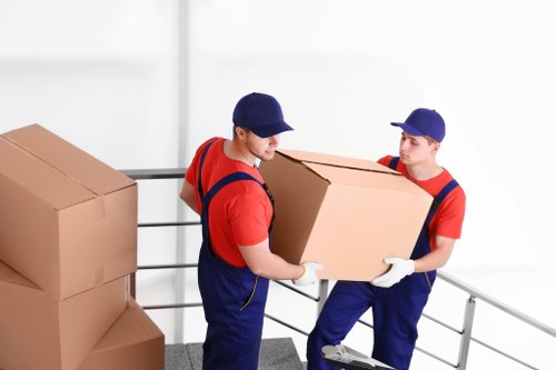 Team member loading a removal van with safety precautions in place