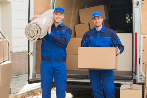 Professional team handling piano removals in Putney with protective wrapping
