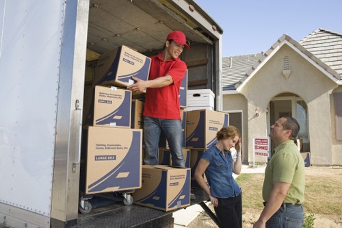 Trained movers handling boxes with care during a removal van job