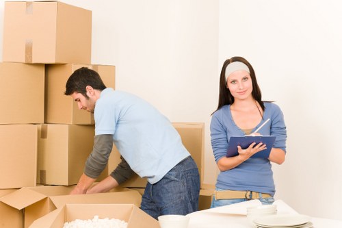 Supervisor checking safe loading procedures near a moving van